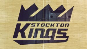 Stockton Kings logo painted on a polished hardwood basketball court floor.